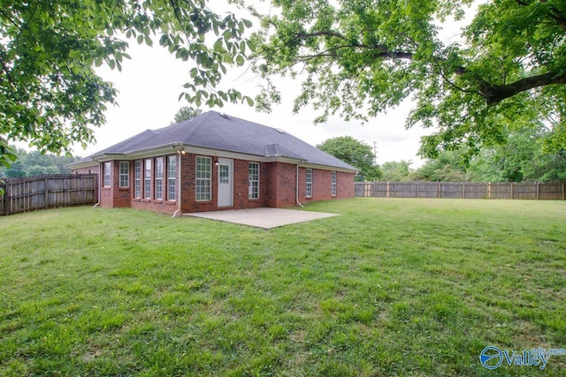 rear view of property featuring brick siding and a patio area