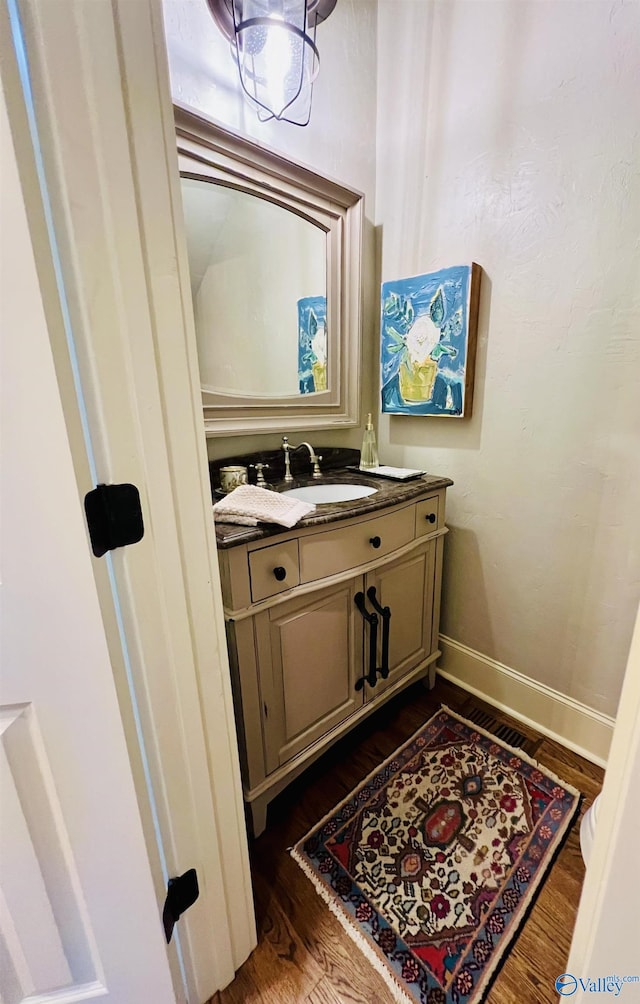 bathroom featuring vanity and hardwood / wood-style flooring