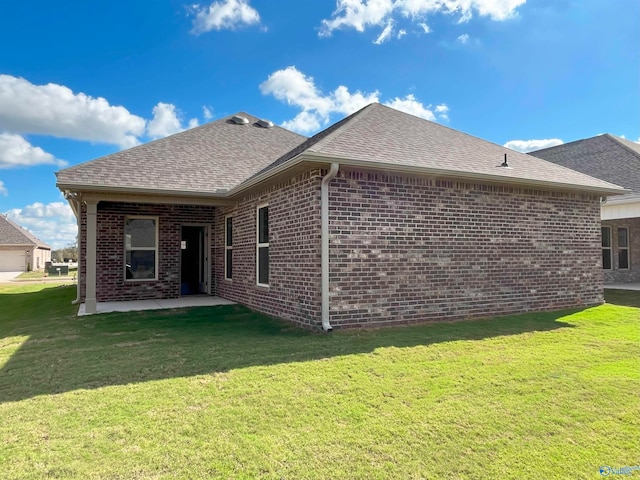 back of house featuring a yard and a patio area