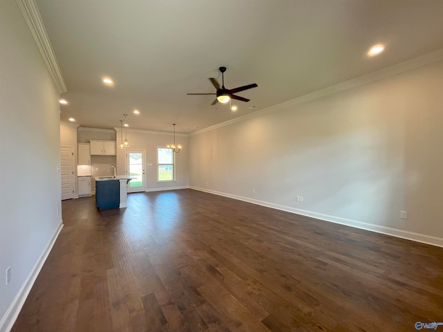 unfurnished living room with ornamental molding, sink, ceiling fan with notable chandelier, and dark hardwood / wood-style floors