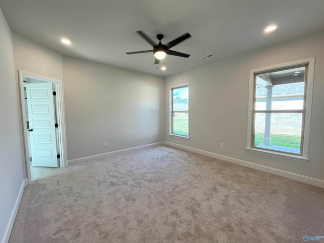 carpeted empty room featuring ceiling fan