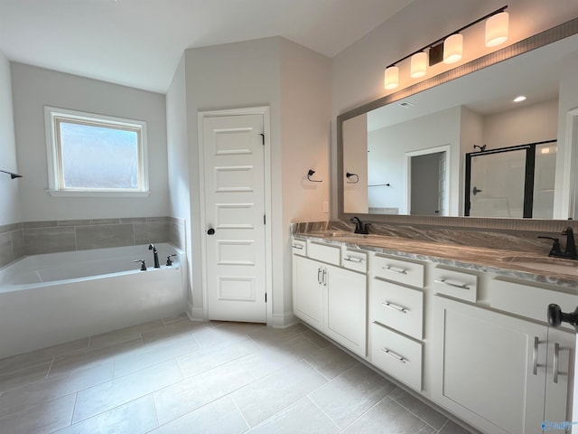 bathroom featuring vanity, plus walk in shower, and tile patterned flooring