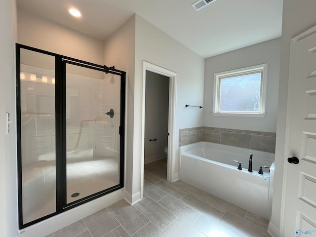 bathroom with shower with separate bathtub and toilet