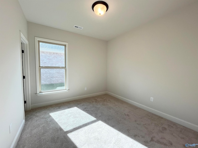 unfurnished room featuring light colored carpet