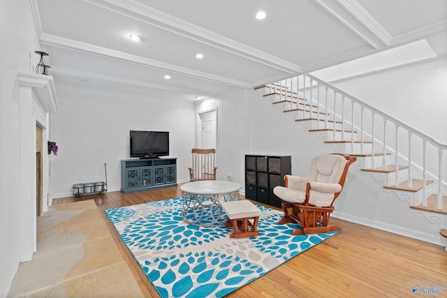 living room featuring beamed ceiling, wood-type flooring, and ornamental molding