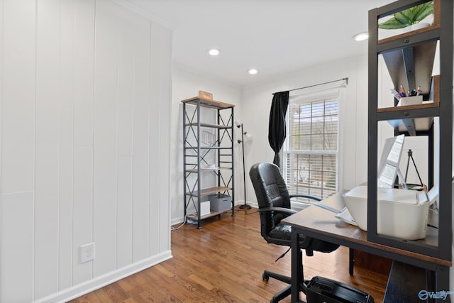 home office with wood-type flooring and crown molding