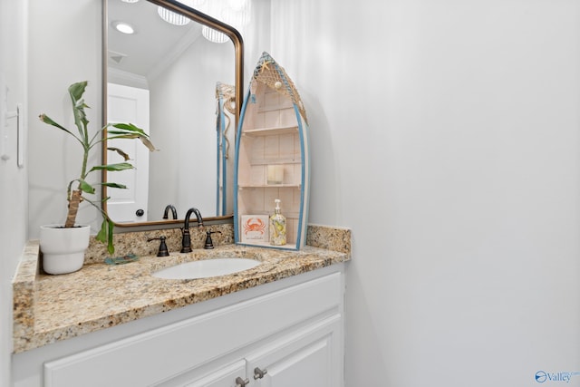 bathroom with vanity and ornamental molding