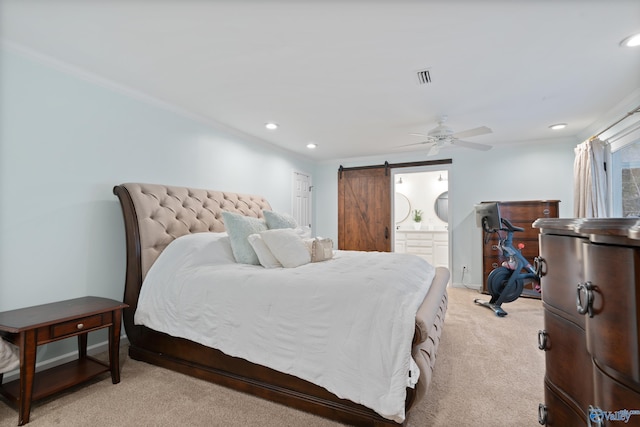 bedroom with ensuite bathroom, light colored carpet, ceiling fan, crown molding, and a barn door