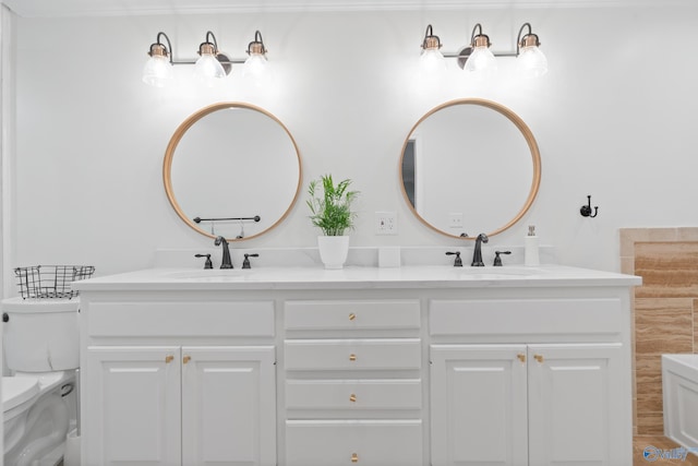 bathroom featuring vanity and toilet