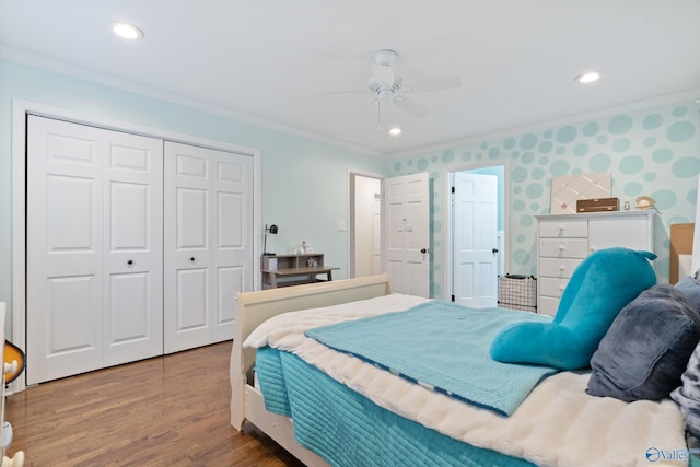 bedroom with wood-type flooring, a closet, ceiling fan, and crown molding