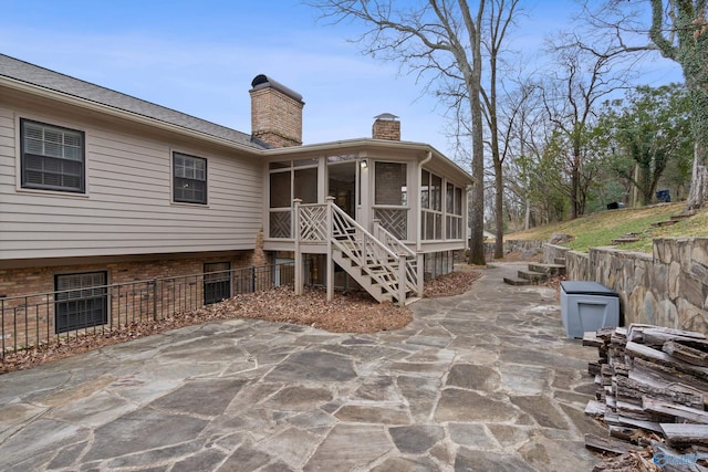 back of house with a sunroom and a patio