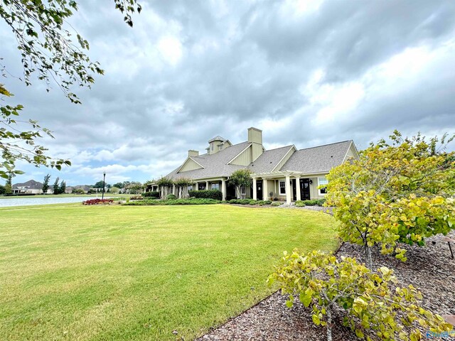 view of front of house featuring a front yard and a water view