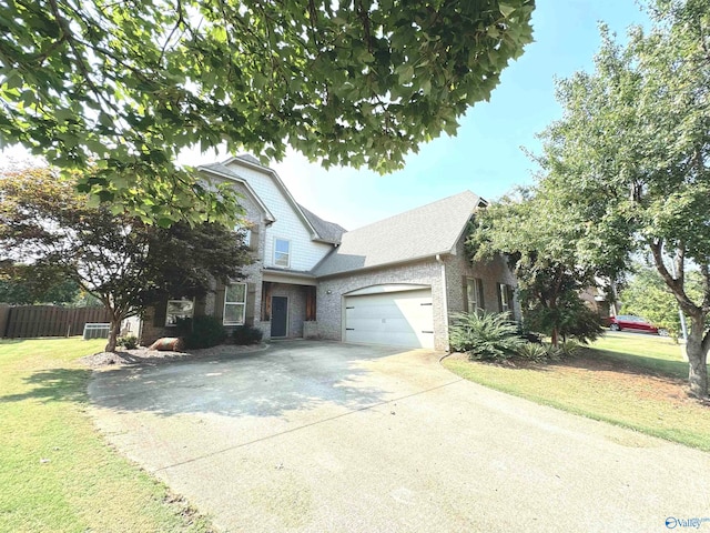 view of front of property featuring a front lawn and a garage