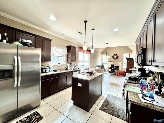 kitchen with crown molding, a center island, light tile patterned flooring, and stainless steel appliances