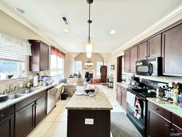 kitchen with black appliances, a center island, a wealth of natural light, and pendant lighting