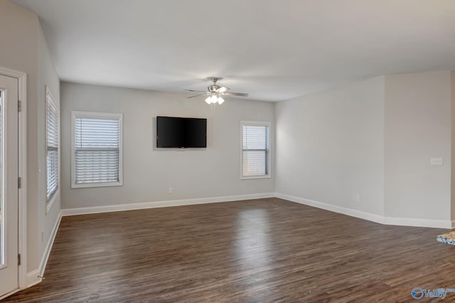 unfurnished room with ceiling fan, a healthy amount of sunlight, and dark hardwood / wood-style floors