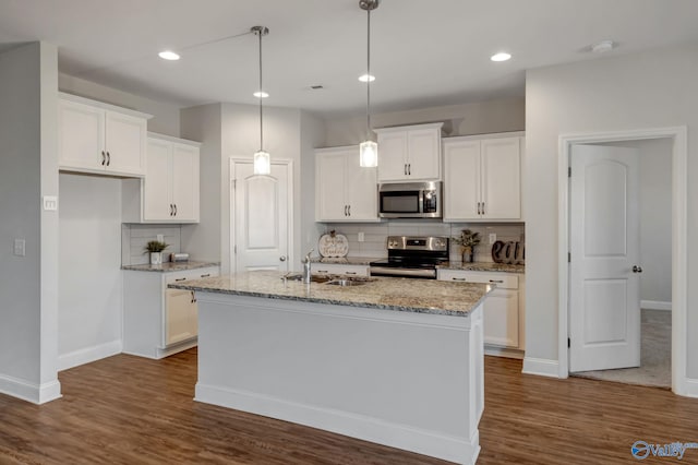 kitchen with white cabinetry, an island with sink, stainless steel appliances, and dark hardwood / wood-style floors