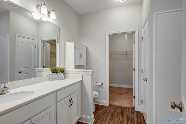 bathroom featuring vanity, toilet, and wood-type flooring