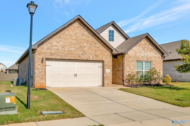 104 Pointe Haven Ct, Huntsville, AL 35824 - view of front of home with brick siding, a garage, a front yard, and central air condition unit