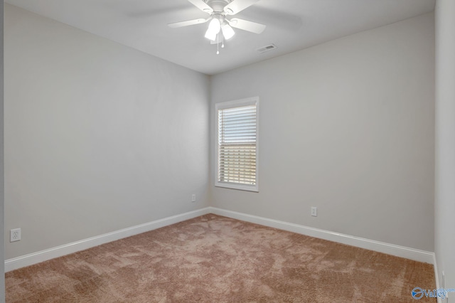 empty room featuring ceiling fan and light colored carpet