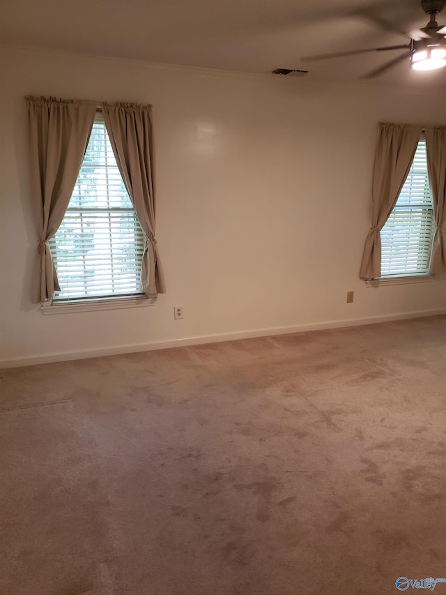 unfurnished room featuring ceiling fan and carpet