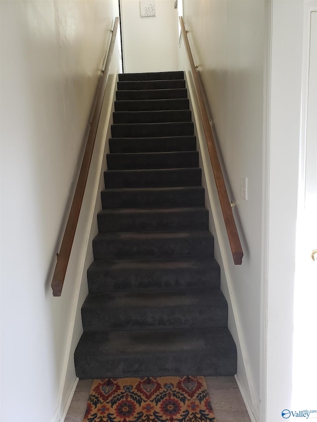 staircase with wood-type flooring