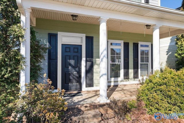 view of exterior entry with covered porch