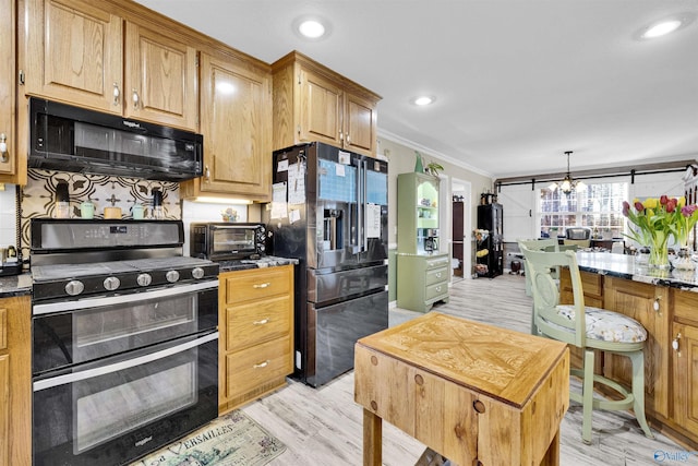 kitchen featuring a toaster, crown molding, double oven range, black microwave, and stainless steel refrigerator with ice dispenser