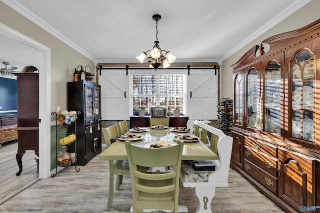 dining space featuring a wealth of natural light, crown molding, and a barn door