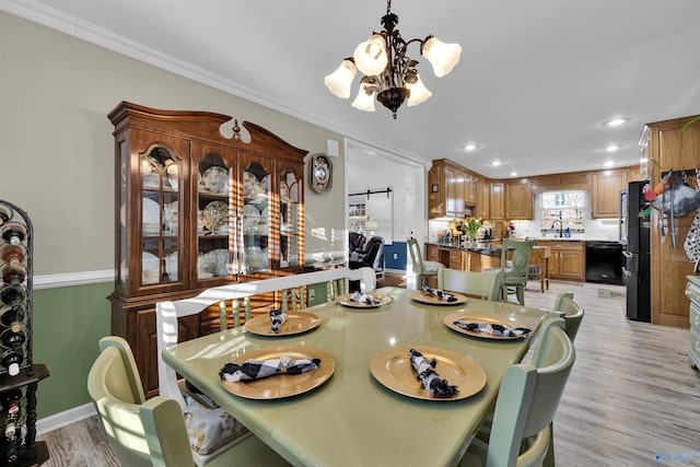 dining area featuring light wood-style flooring, recessed lighting, baseboards, ornamental molding, and an inviting chandelier