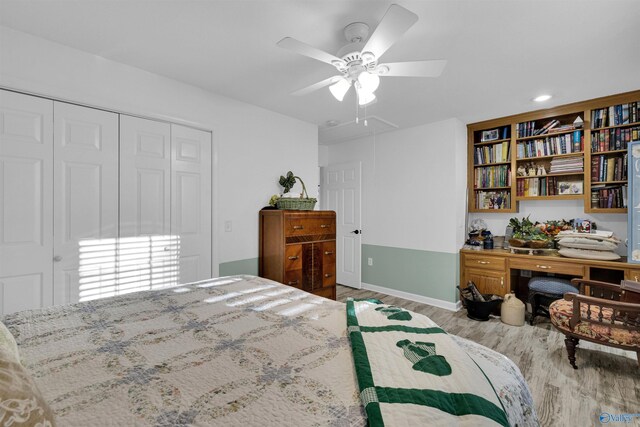 bedroom featuring attic access, a closet, ceiling fan, and wood finished floors