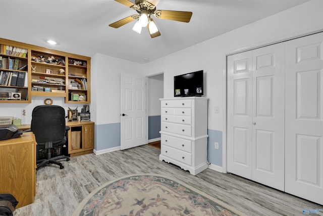 home office with wood finished floors, a ceiling fan, and baseboards