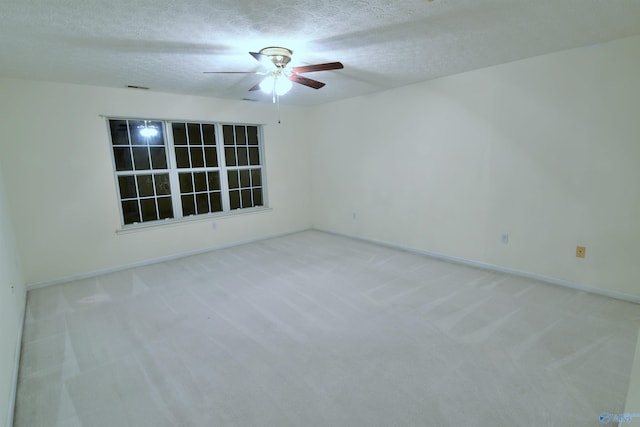 carpeted empty room with a textured ceiling