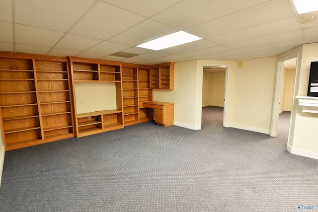 unfurnished living room featuring carpet and a paneled ceiling