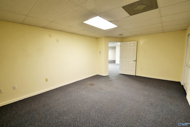 unfurnished room featuring dark colored carpet