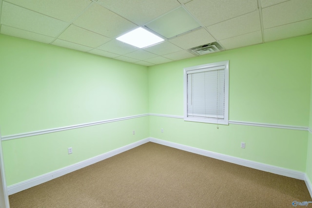 spare room with a drop ceiling and carpet