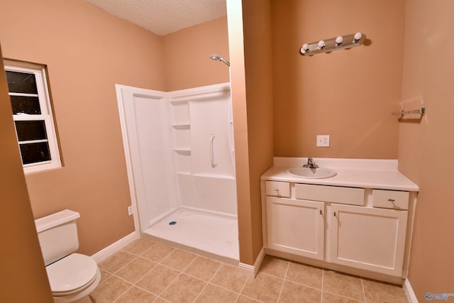 bathroom featuring vanity, a shower, tile patterned floors, toilet, and a textured ceiling