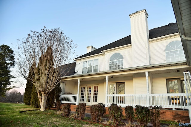 property exterior at dusk featuring a porch