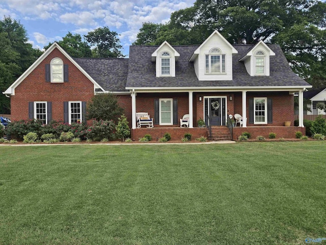 103 Covey Ln, Hazel Green, AL 35750 - new england style home with brick siding, a front yard, covered porch, and roof with shingles