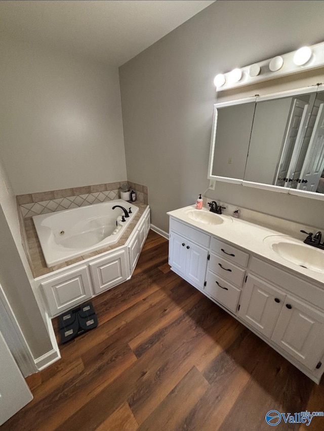 103 Covey Ln, Hazel Green, AL 35750 - bathroom featuring double vanity, a bath, and wood finished floors