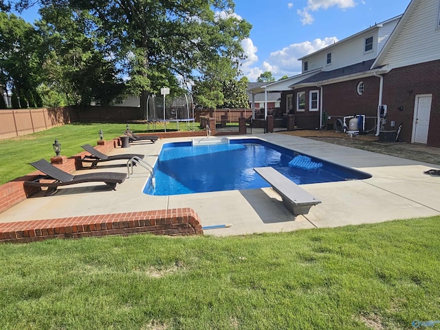 103 Covey Ln, Hazel Green, AL 35750 - view of pool with a trampoline, a fenced backyard, a patio, and a diving board