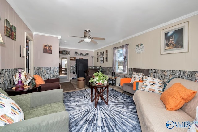 living room with ceiling fan and crown molding