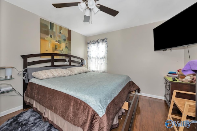 bedroom with ceiling fan and dark hardwood / wood-style floors