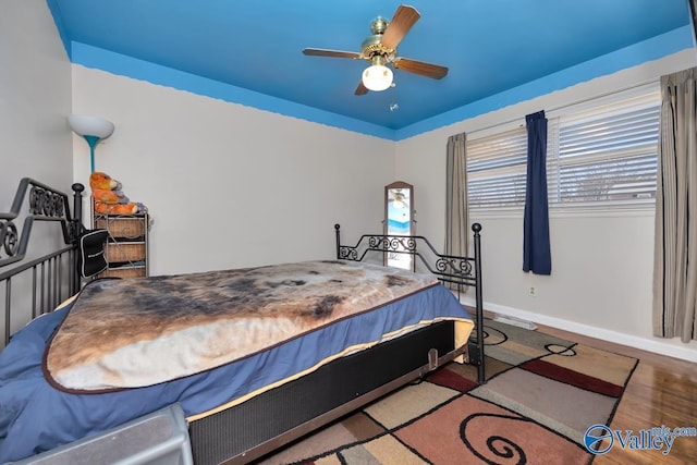 bedroom with ceiling fan and hardwood / wood-style flooring