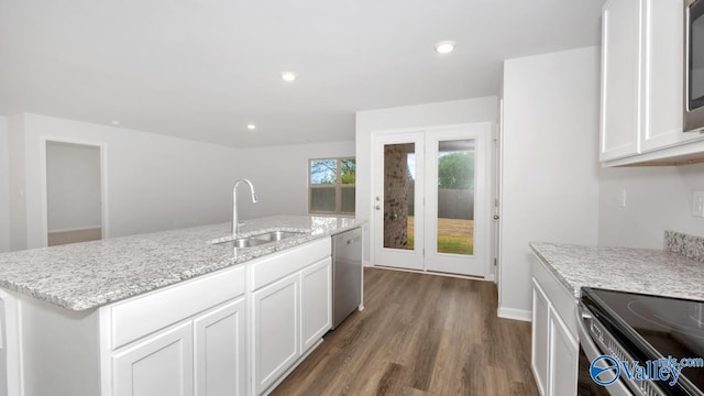 kitchen with white cabinetry, sink, dark hardwood / wood-style flooring, stainless steel dishwasher, and a kitchen island with sink