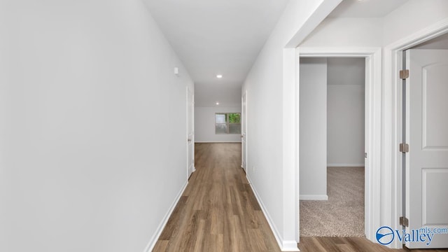 corridor with wood-type flooring