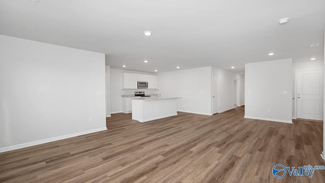 unfurnished living room featuring dark hardwood / wood-style floors