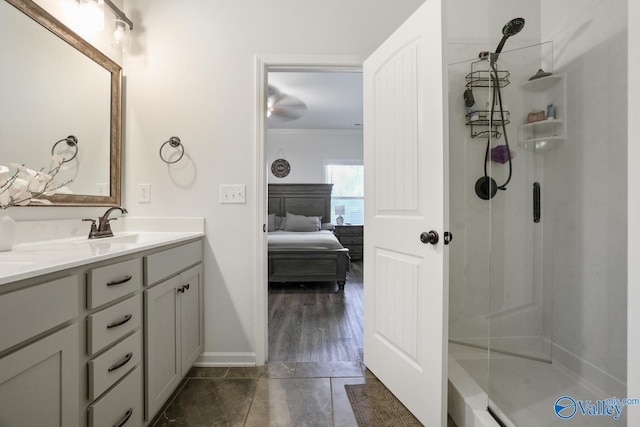 ensuite bathroom with connected bathroom, a stall shower, crown molding, and vanity