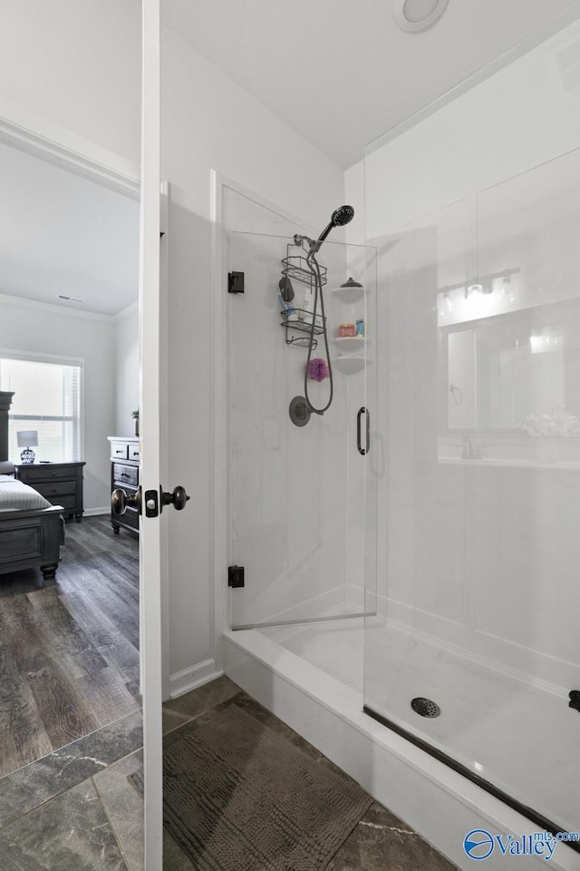 full bathroom featuring a stall shower, ensuite bath, ornamental molding, and wood finished floors