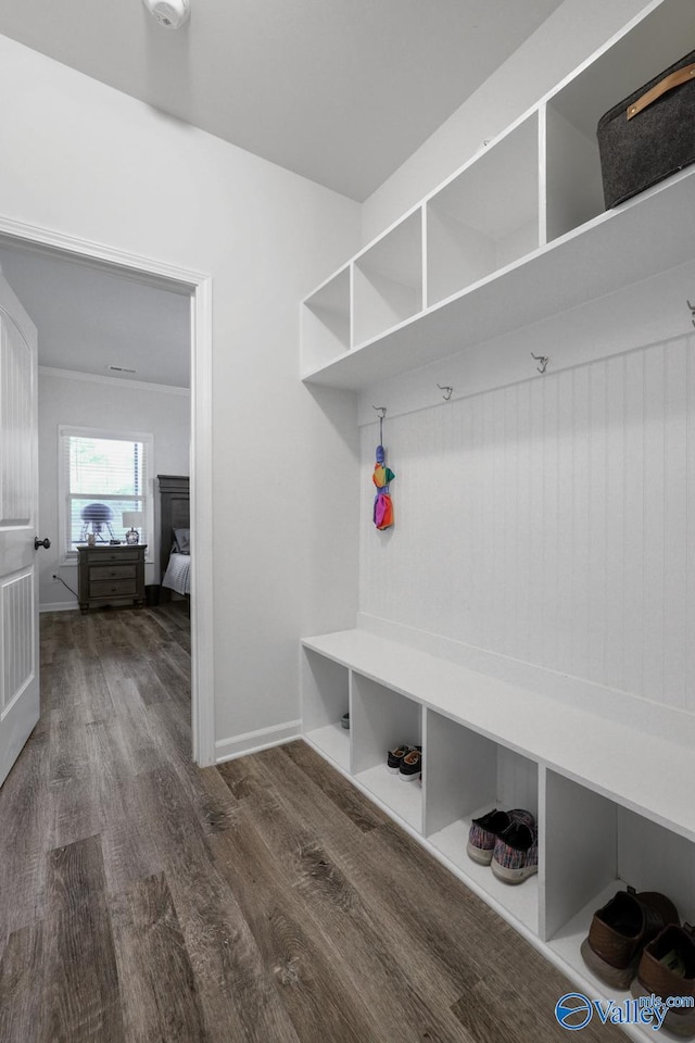 mudroom with wood finished floors and baseboards